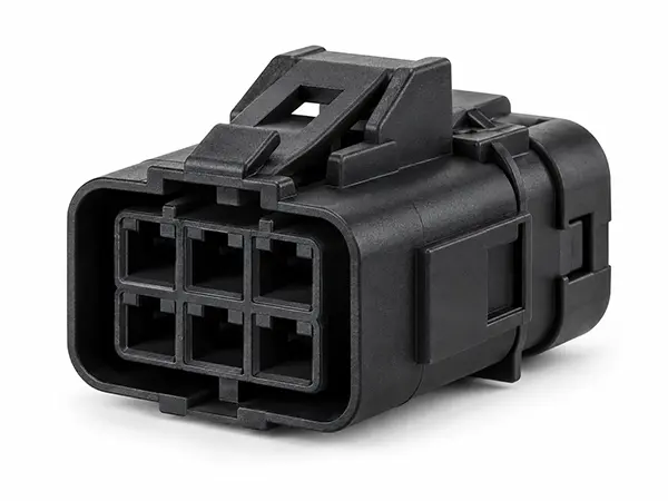 Automotive plastic electrical connector housing with terminal cavities and locking tabs