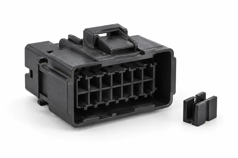 Molded industrial electrical connector housing and insulating spacer